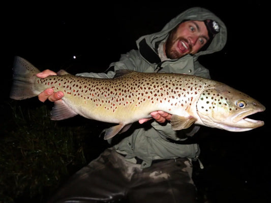 Brian-With-a-huge-brown-trout-fishing-at-night-e1730395436723